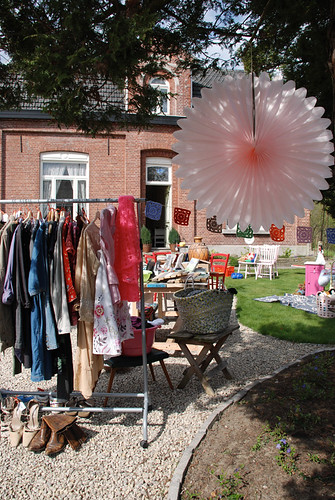 local estate sale clothes and household goods on lawn in front of home