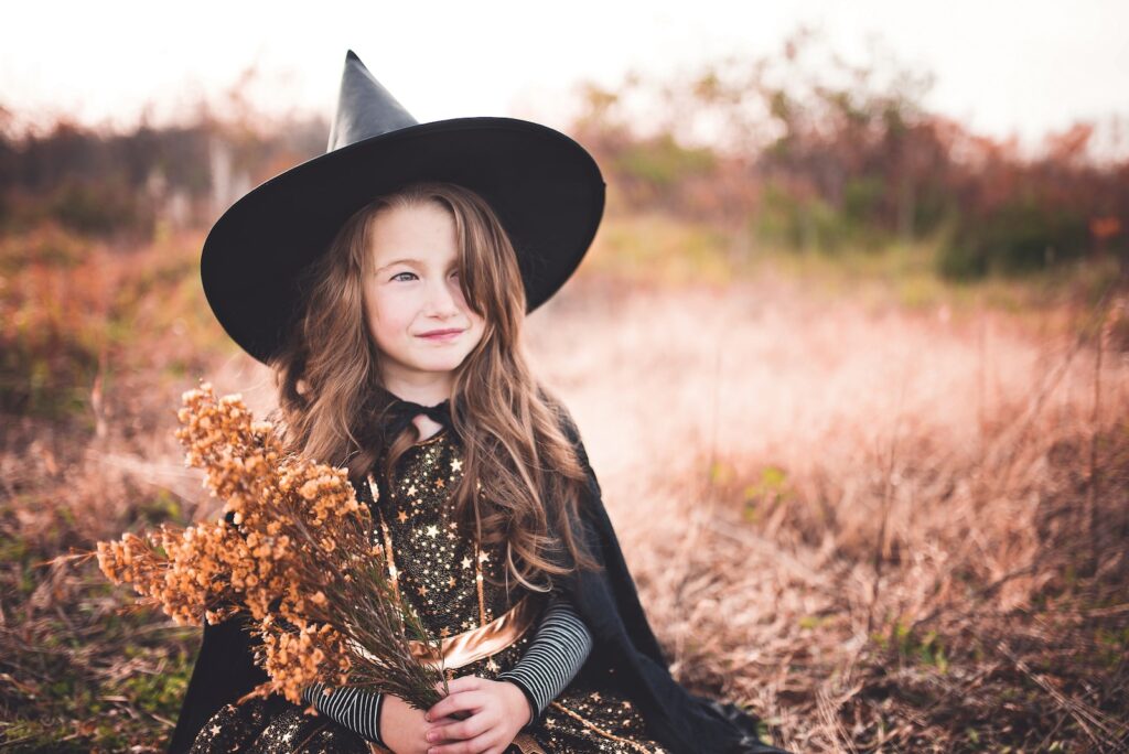 girl wearing black witch holding brown plant eco friendly