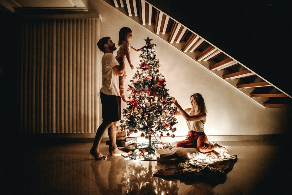 Family Decorating Their non toxic Christmas Tree