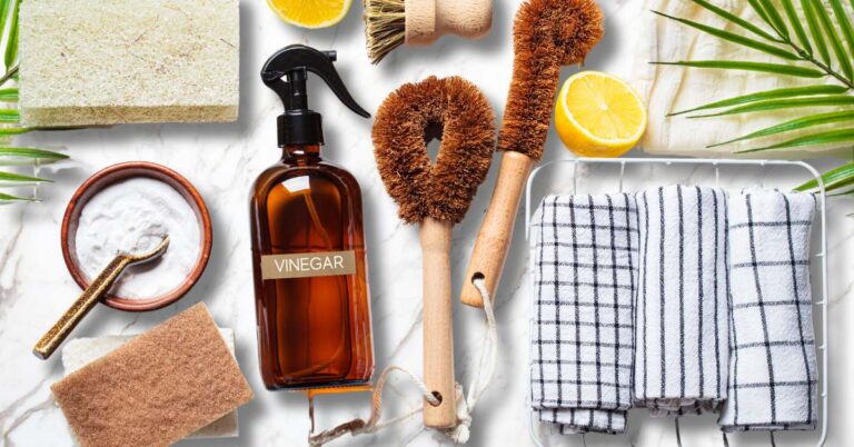 non toxic living cleaning products baking soda, vinegar, natural towels, lemon and wood handle brushes
