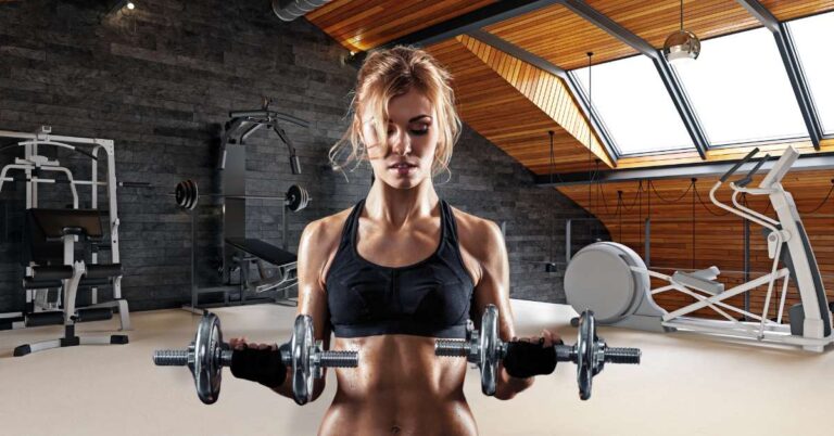 pretty blonde fit women using best non toxic dumbbells chrome colored in a home gym